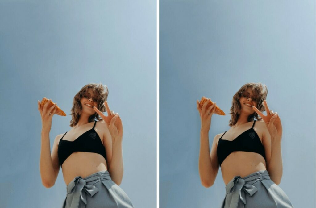 woman wearing a black crop top holding a slice of pizza