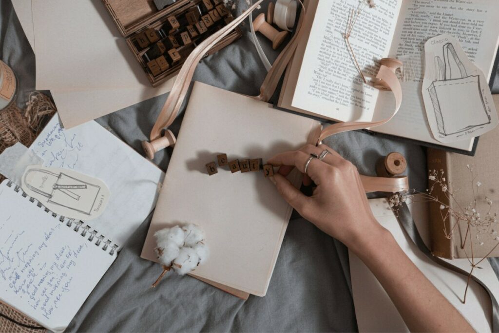 overhead shot of writing materials and letter blocks