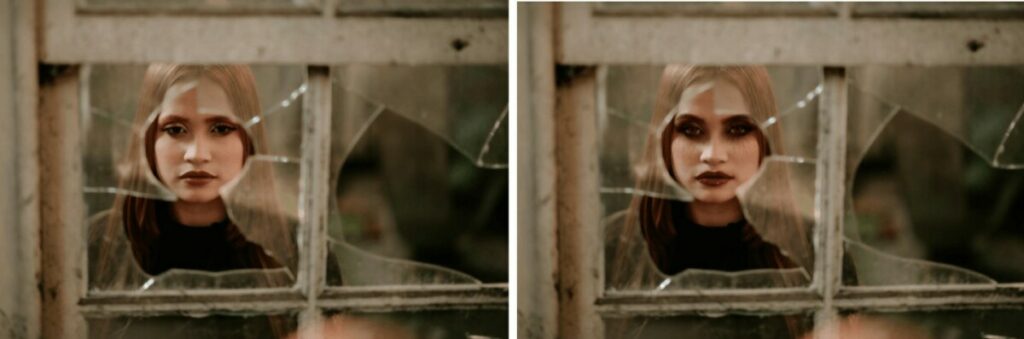 woman staring through a broken window wearing vampire makeup