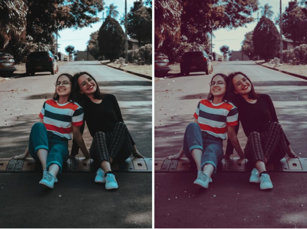 two girls sitting in the middle of the street