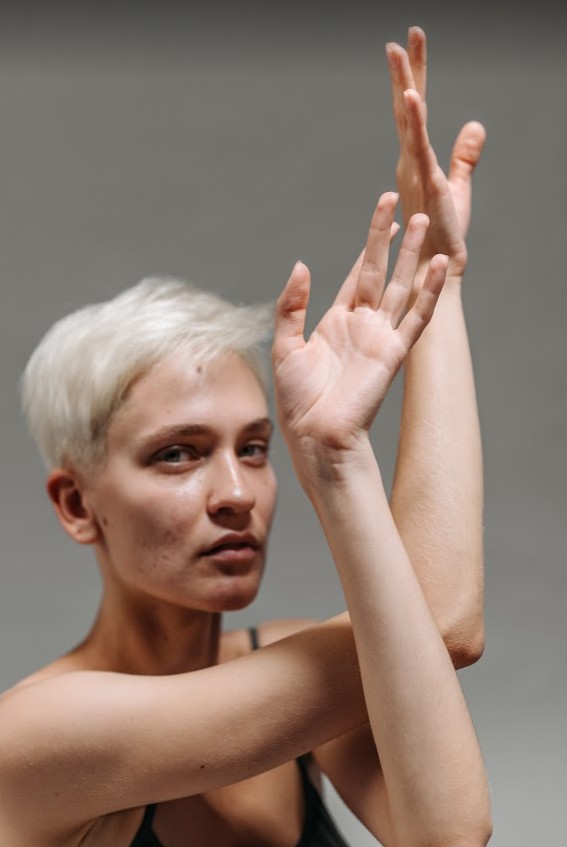 self-portrait of woman posing with her hands