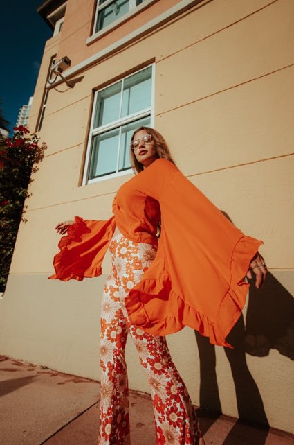 woman in orange bell sleeves